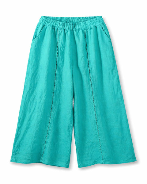 Pantalón de mujer de pernera ancha con cintura elástica y detalles calados verticales, ligero y fluido.